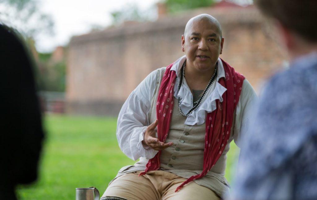 Cody Grant, Pueblo of Isleta/Eastern Band Cherokee, interacting with visitors in Colonial Williamsburg. Grant will portray Oconostota as part of the Nation Builder program. Grant will portray Oconostota as part of the Nation Builder program. (Image courtesy of The Colonial Williamsburg Foundation.)