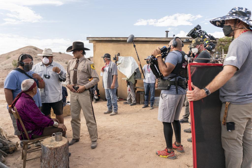 Joe Paul Comanche as Navajo Medicine Man, Kiowa Gordon as Jim Chee, and Director Chris Eyre - Dark Winds _ Season 1, Episode 1 - Photo Credit: Michael Moriatis/AMC
