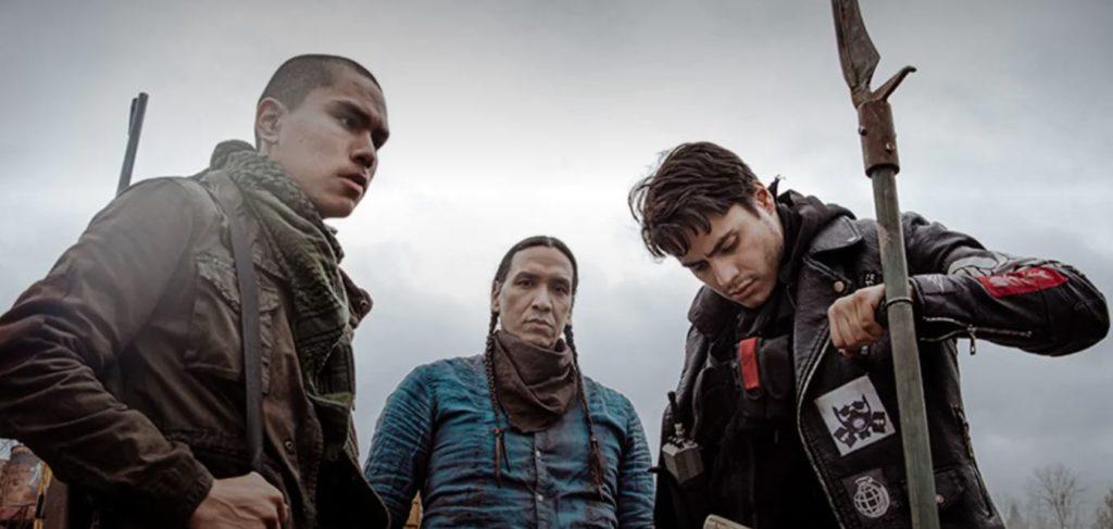 Three Native actors who appear disheveled and traumatized.